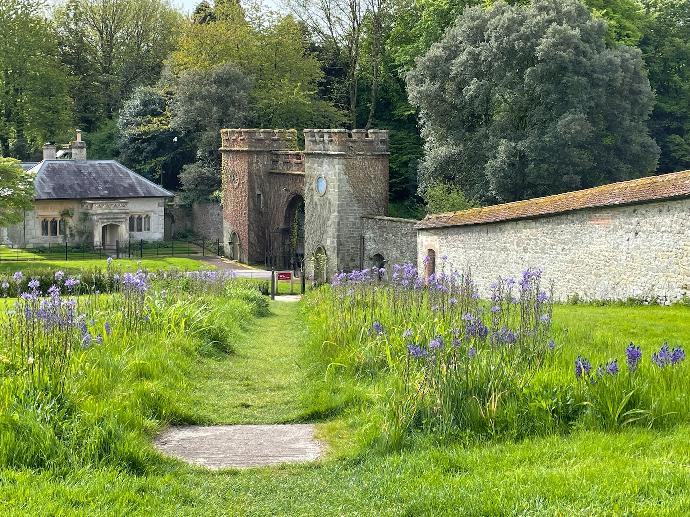 a stone building surrounded by lush green grass