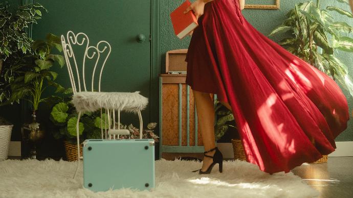 woman in red dress standing on white carpet