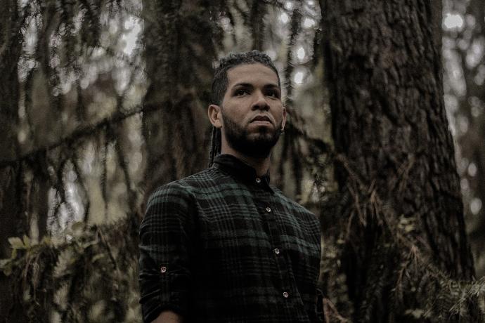 a man standing in the middle of a forest