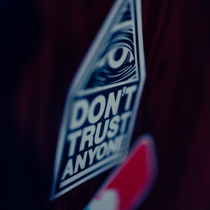a close up of a don't trust anyone sticker
